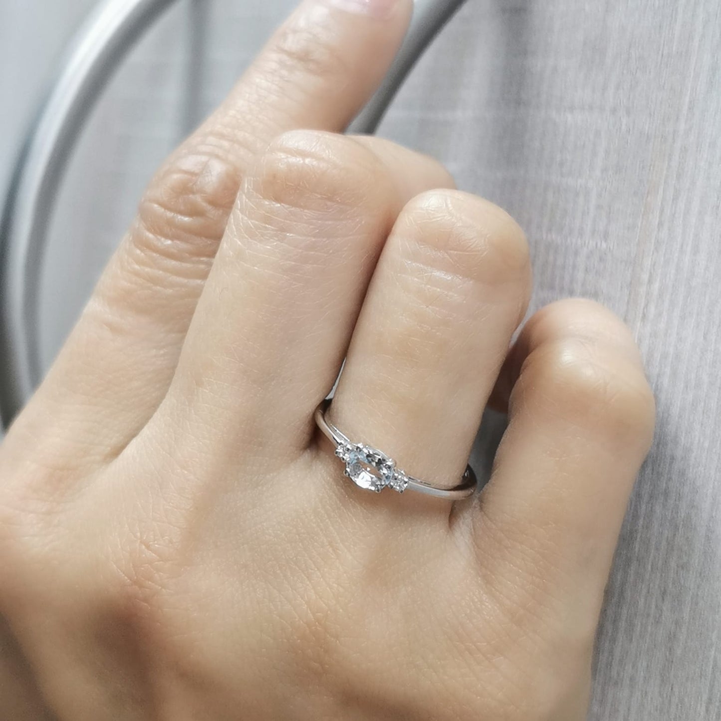 Minimalist oval aquamarine and diamond ring in 18K gold – March birthstone ring.