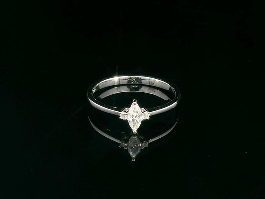 18K gold marquise diamond ring featuring a 0.19-carat marquise-cut center stone with 0.04-carat round diamond accents. Perfect as an engagement ring, stacking ring, or elegant everyday jewelry