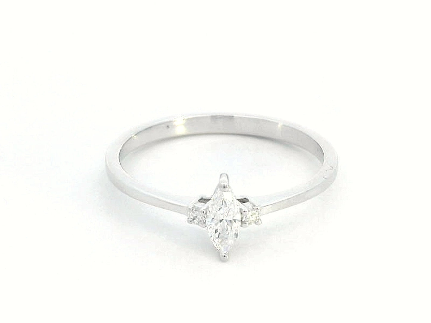 18K gold marquise diamond ring featuring a 0.19-carat marquise-cut center stone with 0.04-carat round diamond accents. Perfect as an engagement ring, stacking ring, or elegant everyday jewelry