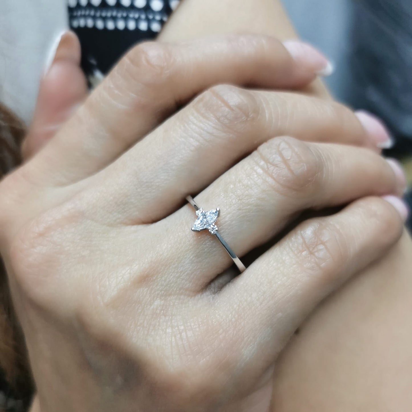 18K gold marquise diamond ring featuring a 0.19-carat marquise-cut center stone with 0.04-carat round diamond accents. Perfect as an engagement ring, stacking ring, or elegant everyday jewelry