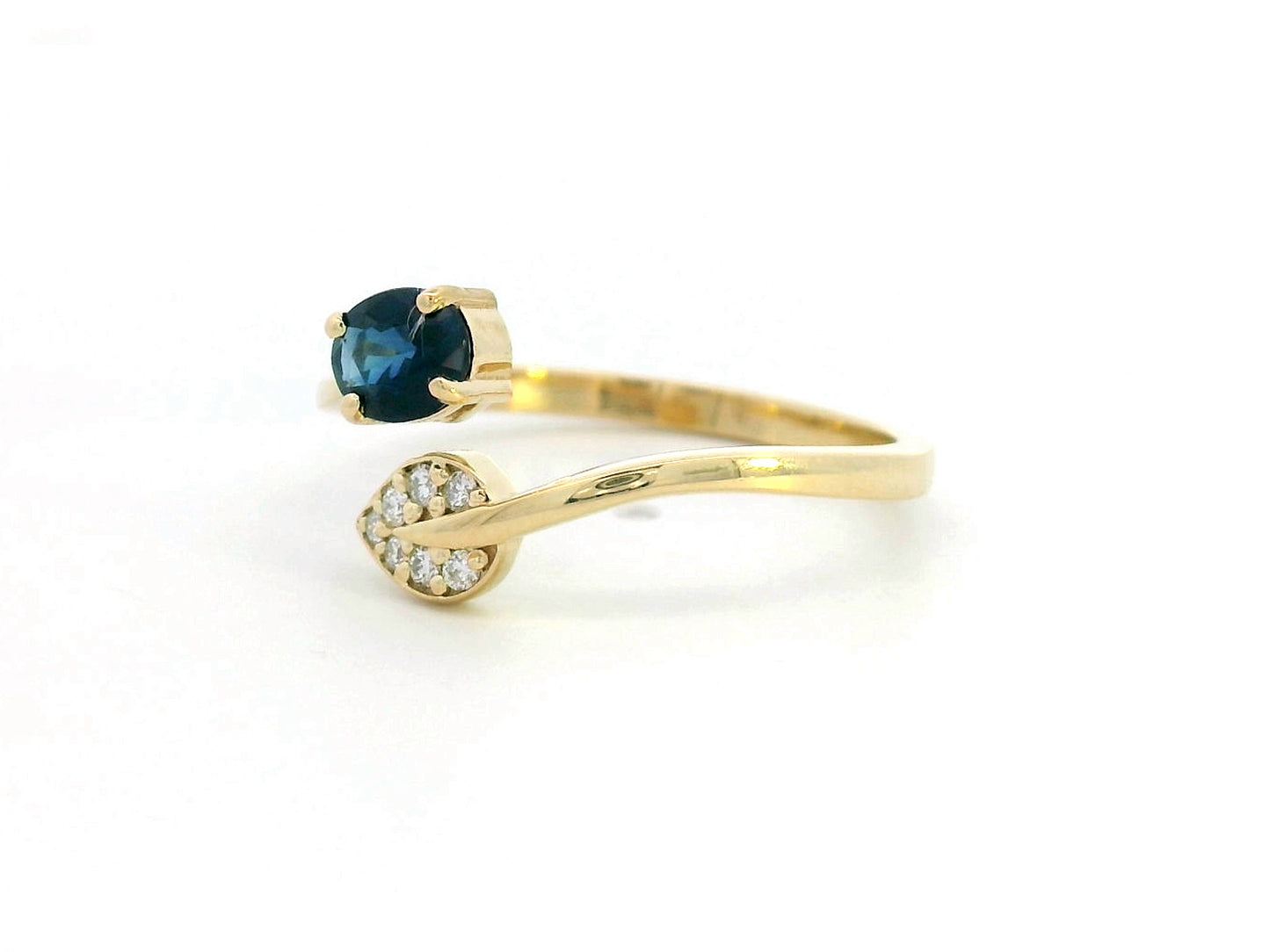 18K yellow gold sapphire and diamond ring featuring a 0.45-carat blue sapphire and 0.06-carat diamonds in an elegant bypass design