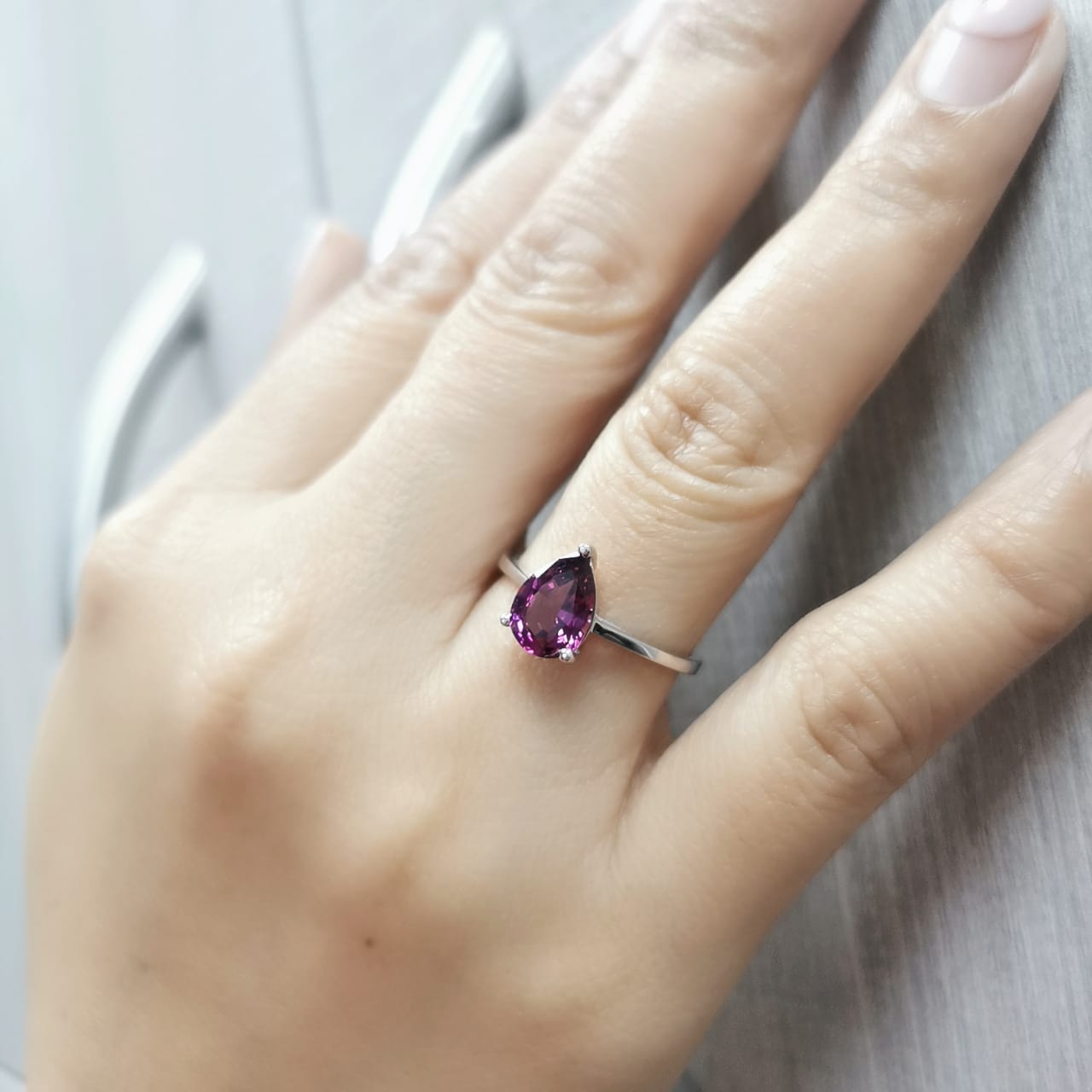 18K white gold pear-shaped Rhodolite ring with a smooth polished band, featuring a minimalist and timeless design.