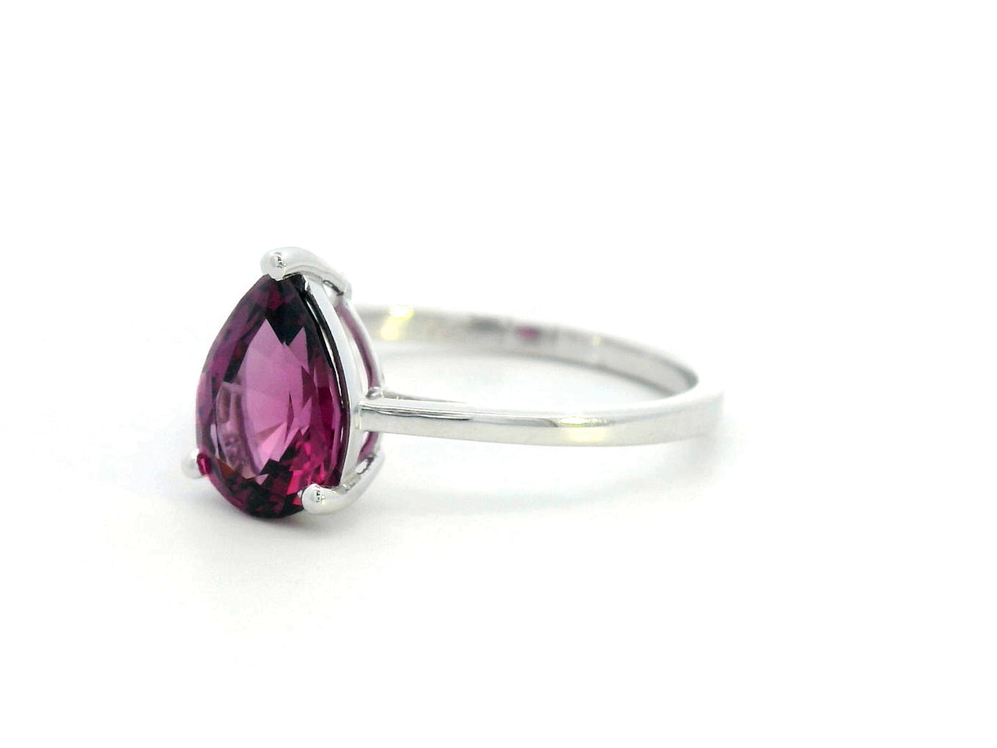 18K white gold pear-shaped Rhodolite ring with a smooth polished band, featuring a minimalist and timeless design.