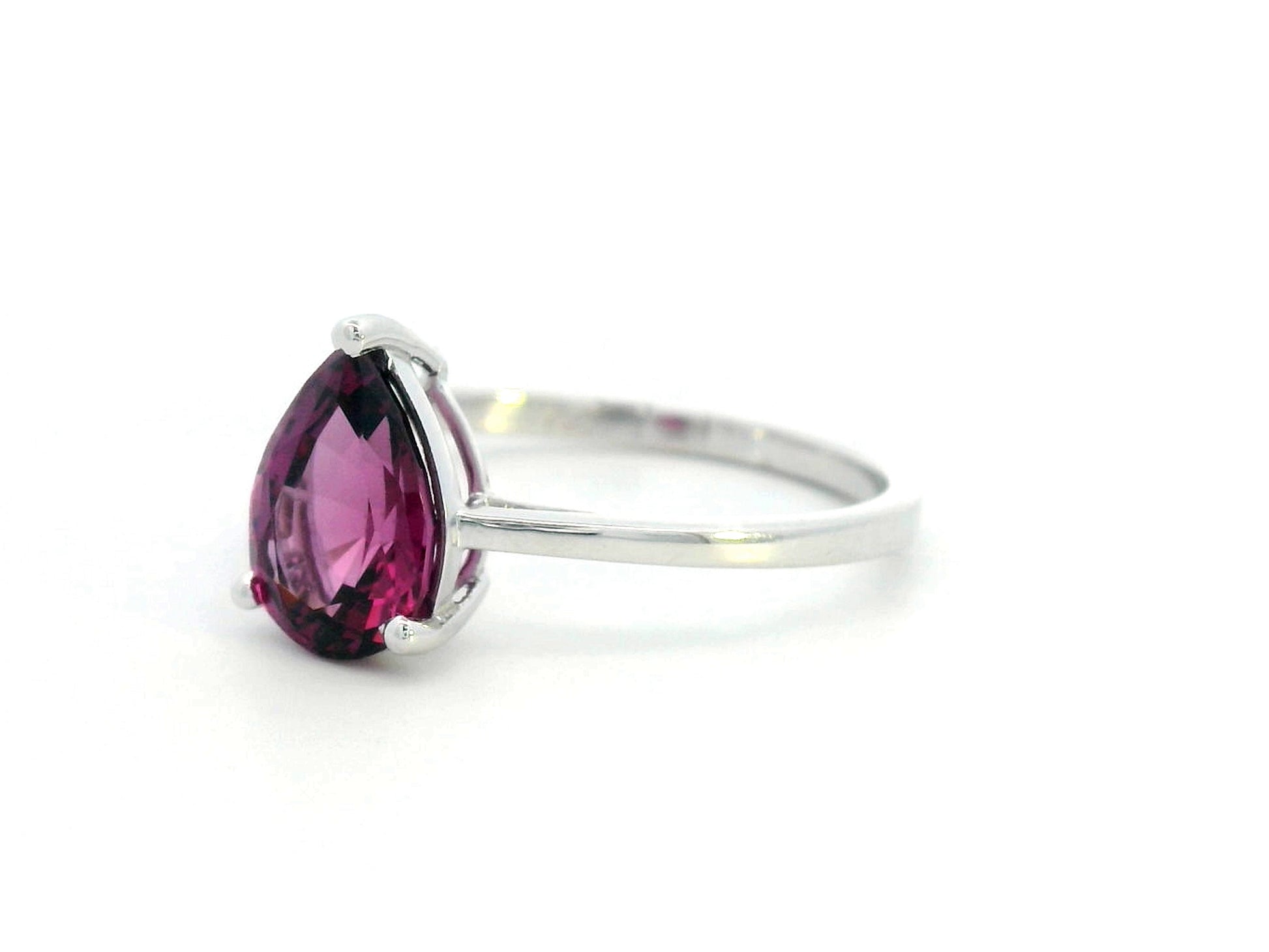 18K white gold pear-shaped Rhodolite ring with a smooth polished band, featuring a minimalist and timeless design.