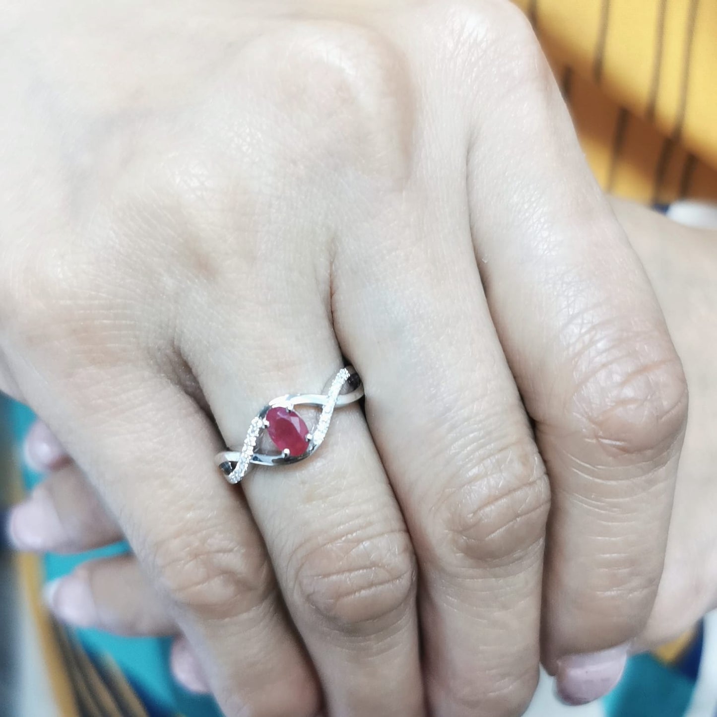 18K White Gold Infinity Ring with 0.48 Carat Oval Ruby and 0.09 Carat Diamonds