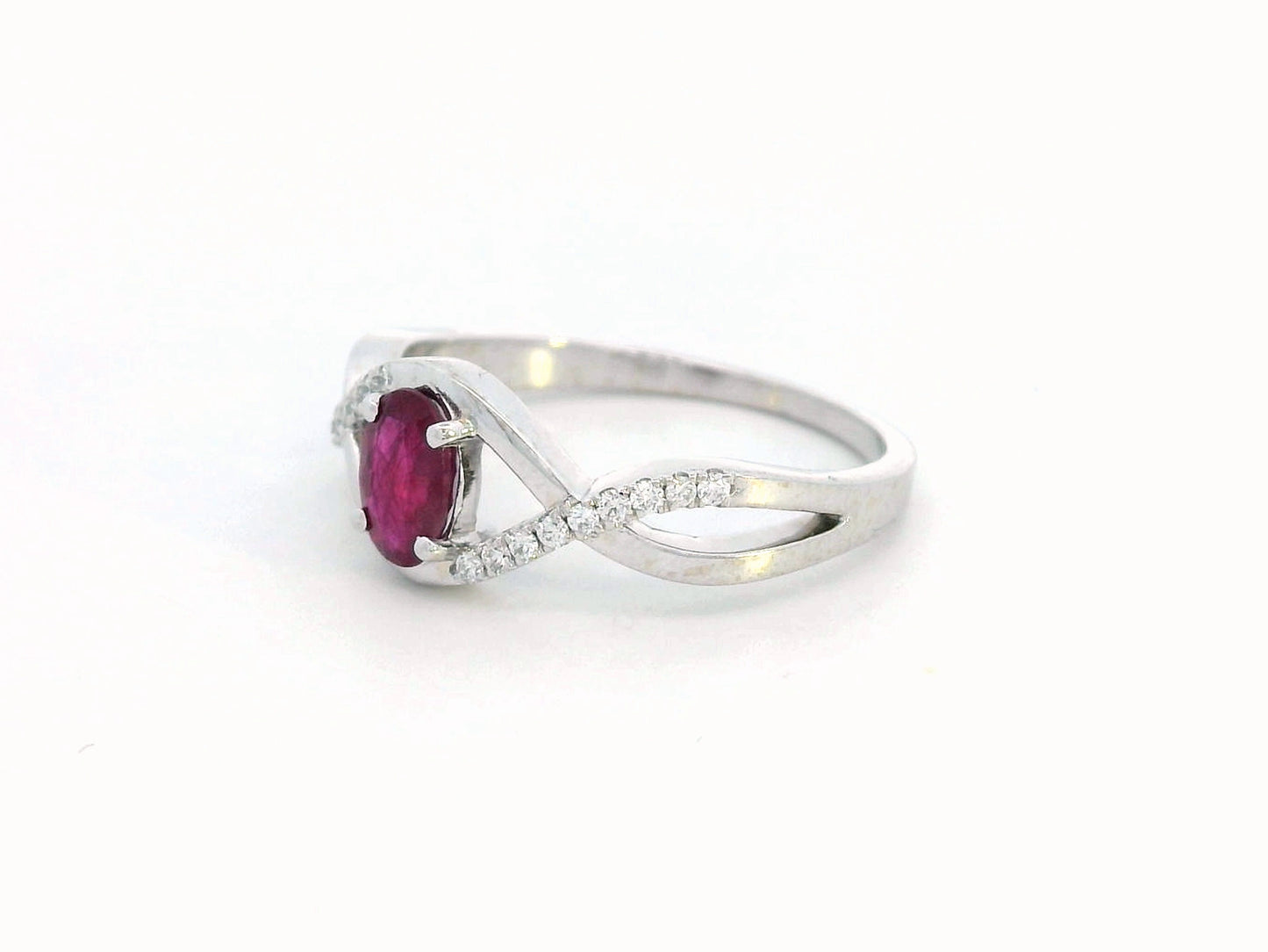 18K White Gold Infinity Ring with 0.48 Carat Oval Ruby and 0.09 Carat Diamonds