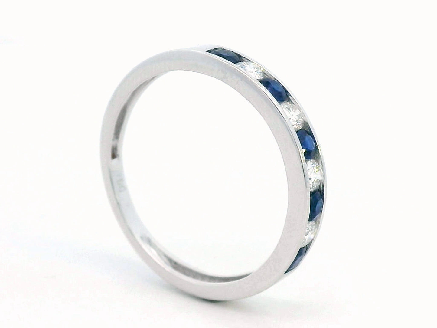 18K white gold sapphire and diamond channel set eternity ring with alternating round blue sapphires and diamonds