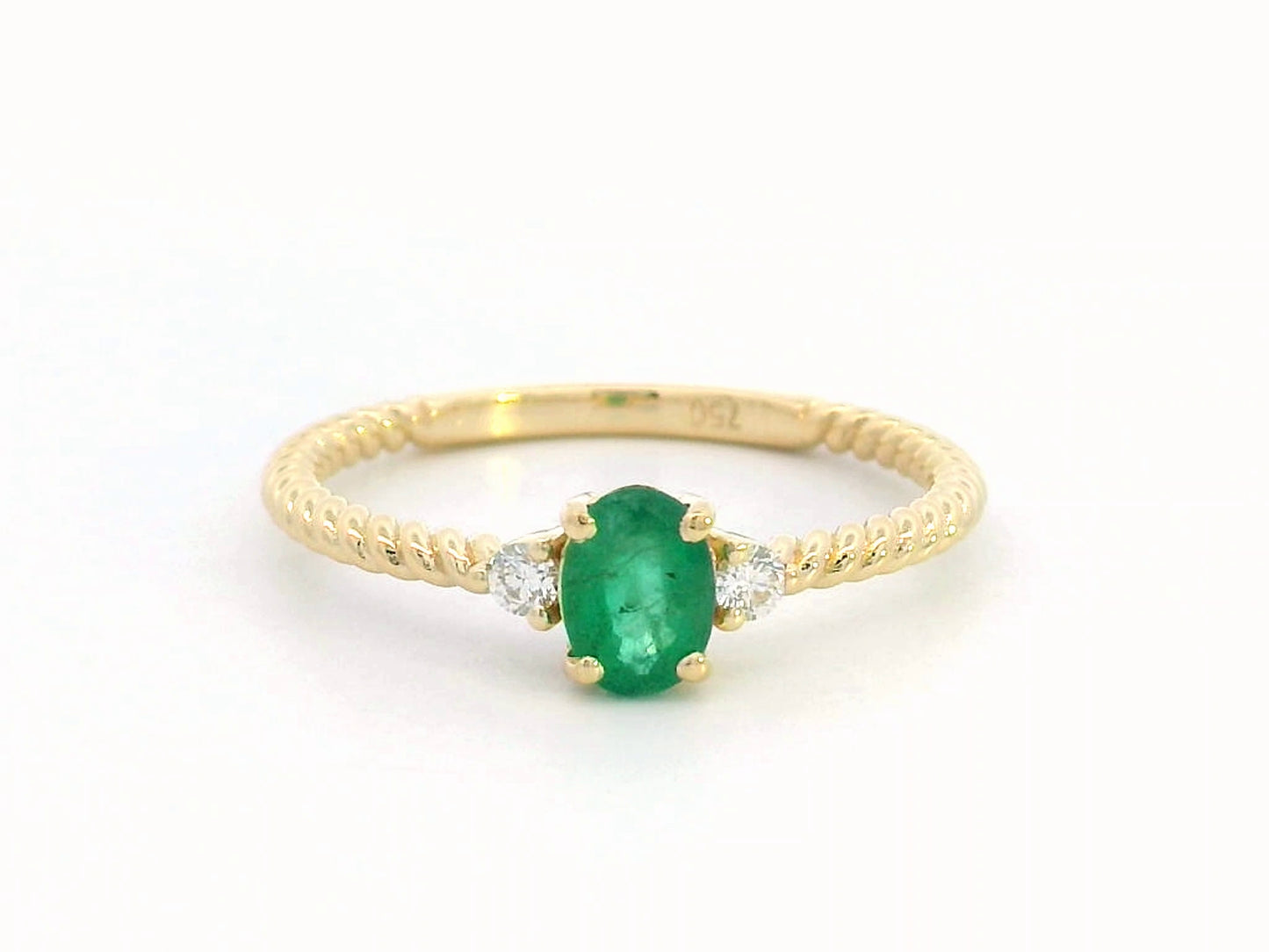 18K gold twisted band emerald and diamond ring featuring a 0.44-carat oval emerald and 0.07-carat diamonds – perfect for stacking, engagement, or as a May birthstone ring
