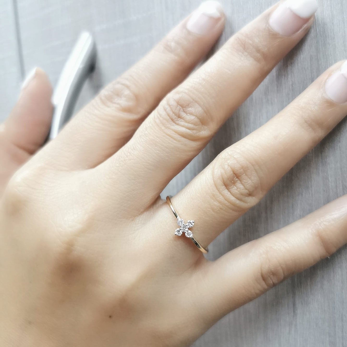 Minimalist 18K gold diamond cluster ring featuring a dainty 0.13ct floral-inspired design, perfect for stacking or daily wear.