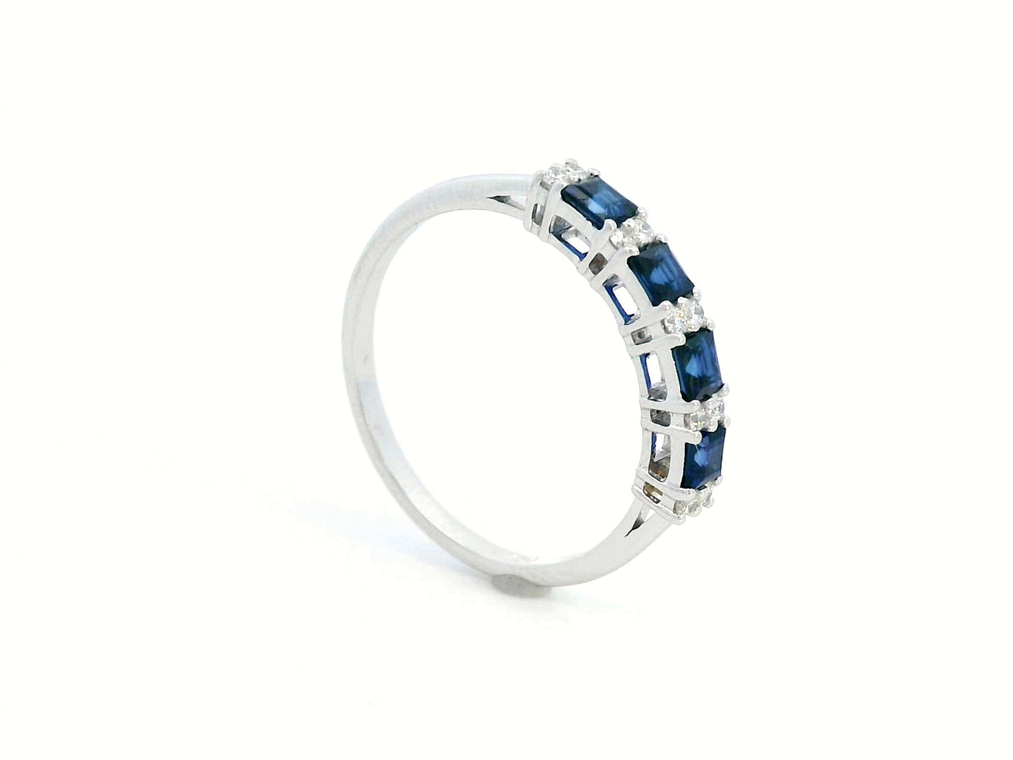 18K white gold sapphire and diamond eternity ring featuring square-cut blue sapphires and round white diamonds in a half-eternity design.