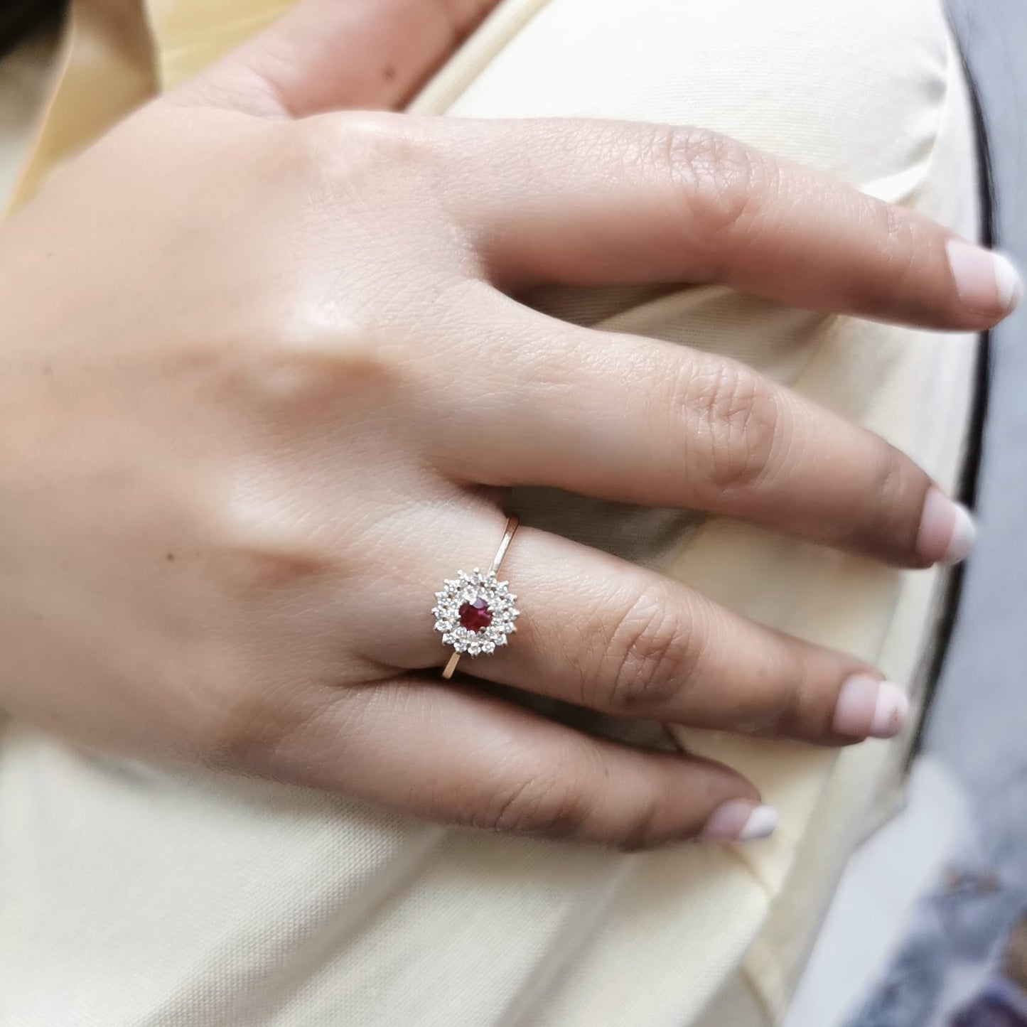 18K gold ruby and diamond halo ring featuring a 0.20-carat deep red ruby and 0.22-carat diamond halo – a vintage-inspired birthstone and engagement ring