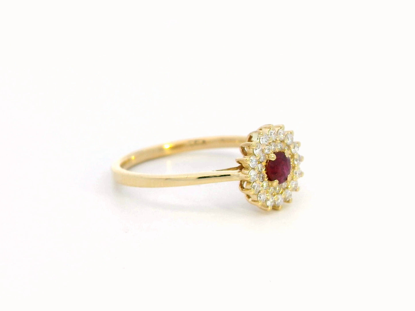 18K gold ruby and diamond halo ring featuring a 0.20-carat deep red ruby and 0.22-carat diamond halo – a vintage-inspired birthstone and engagement ring