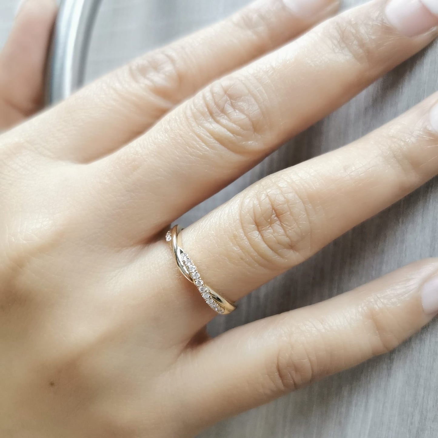 18K gold diamond twist band featuring 0.13 carats of round-cut diamonds – elegant stacking ring, perfect for weddings and special occasions.