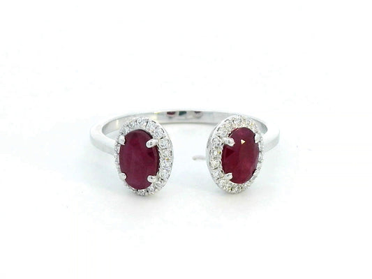 Elegant 18K gold bypass ring featuring two 1.07-carat oval rubies, accented by 0.17 carats of diamonds in a halo setting. A timeless statement piece