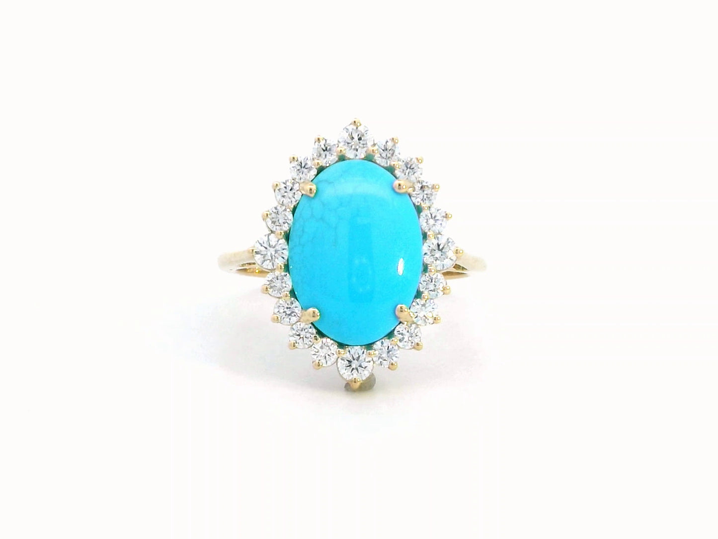 Elegant 18K gold ring featuring a 2.86-carat oval turquoise center stone, surrounded by a sparkling 0.69-carat diamond halo. A timeless statement piece.