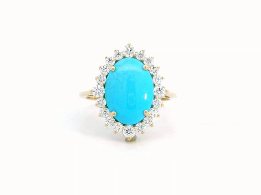 Elegant 18K gold ring featuring a 2.86-carat oval turquoise center stone, surrounded by a sparkling 0.69-carat diamond halo. A timeless statement piece.