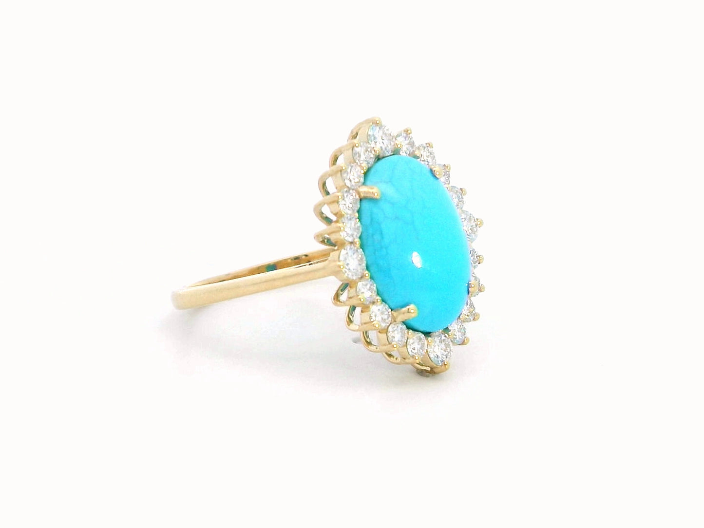 Elegant 18K gold ring featuring a 2.86-carat oval turquoise center stone, surrounded by a sparkling 0.69-carat diamond halo. A timeless statement piece.