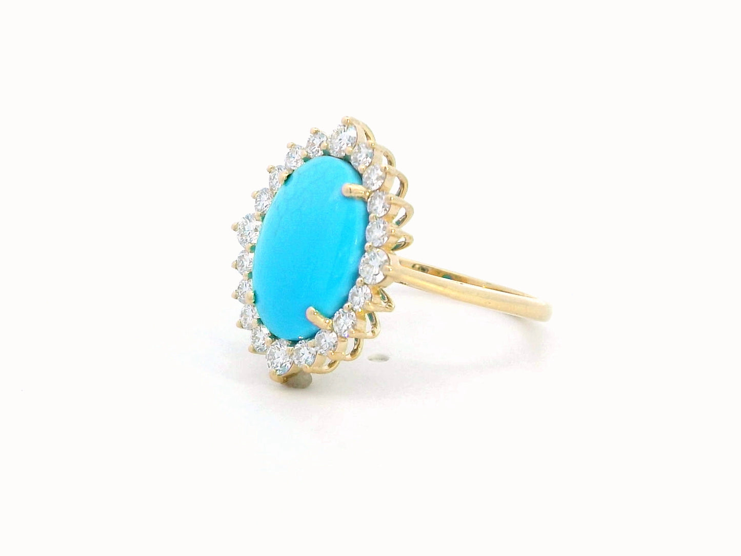 Elegant 18K gold ring featuring a 2.86-carat oval turquoise center stone, surrounded by a sparkling 0.69-carat diamond halo. A timeless statement piece.