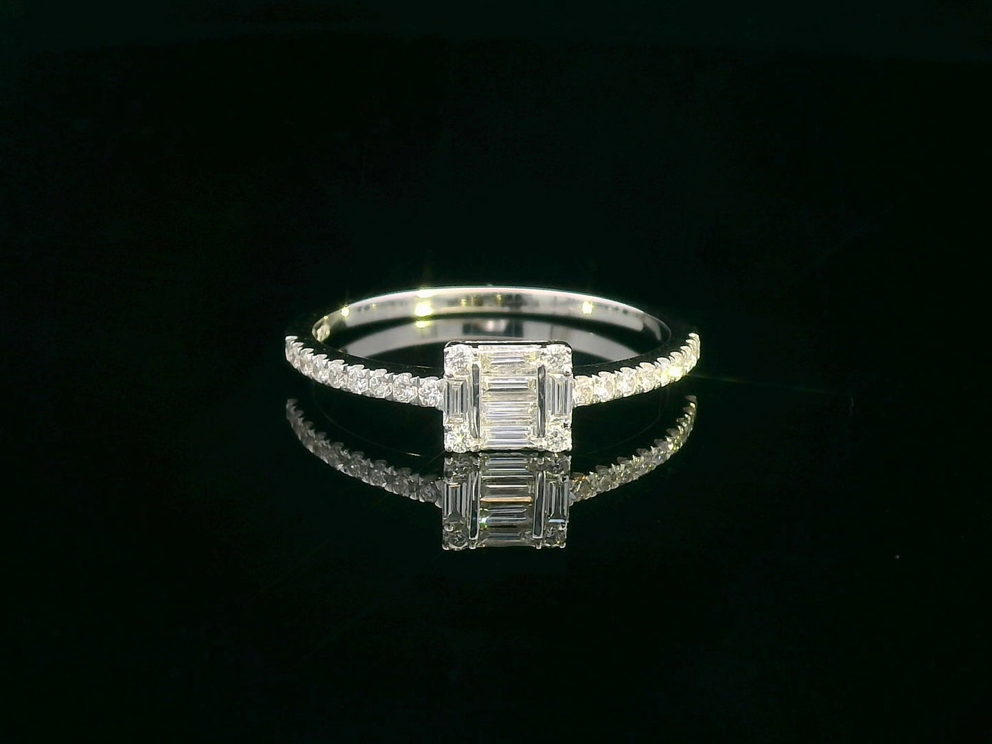 Delicate 18K gold ring featuring 0.28 carats of round and baguette diamonds, set on a diamond-studded band. A timeless piece for any occasion