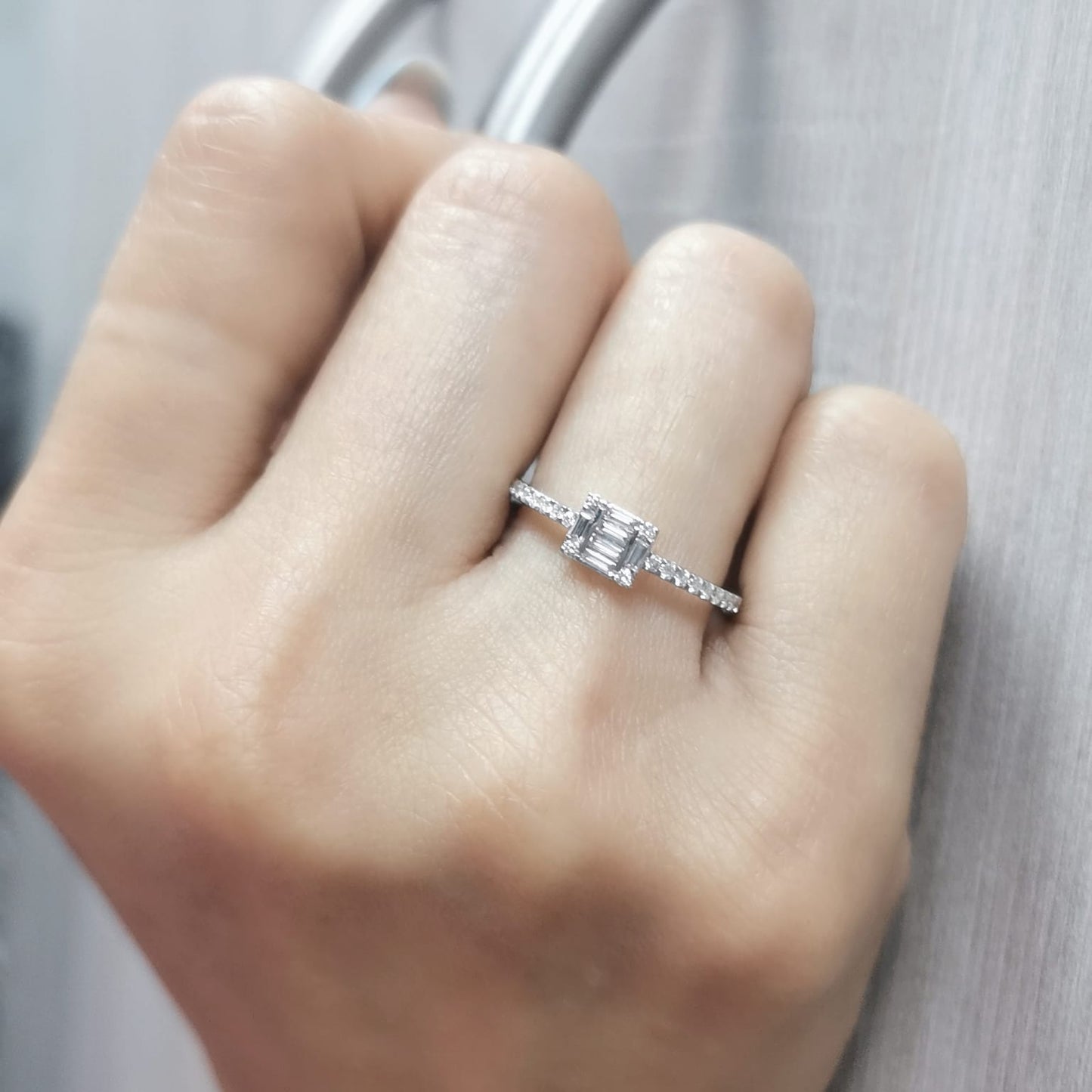 Delicate 18K gold ring featuring 0.28 carats of round and baguette diamonds, set on a diamond-studded band. A timeless piece for any occasion