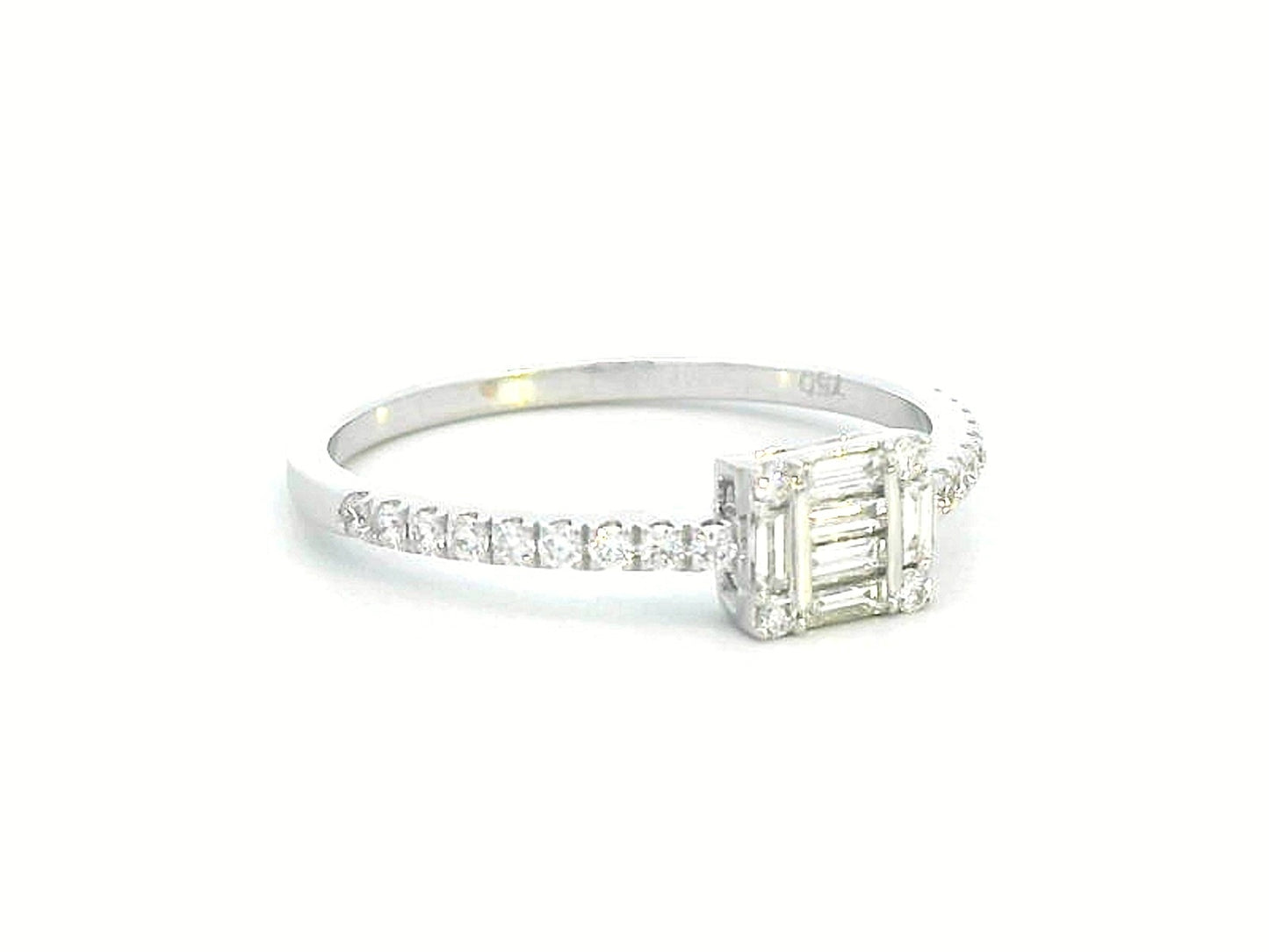 Delicate 18K gold ring featuring 0.28 carats of round and baguette diamonds, set on a diamond-studded band. A timeless piece for any occasion