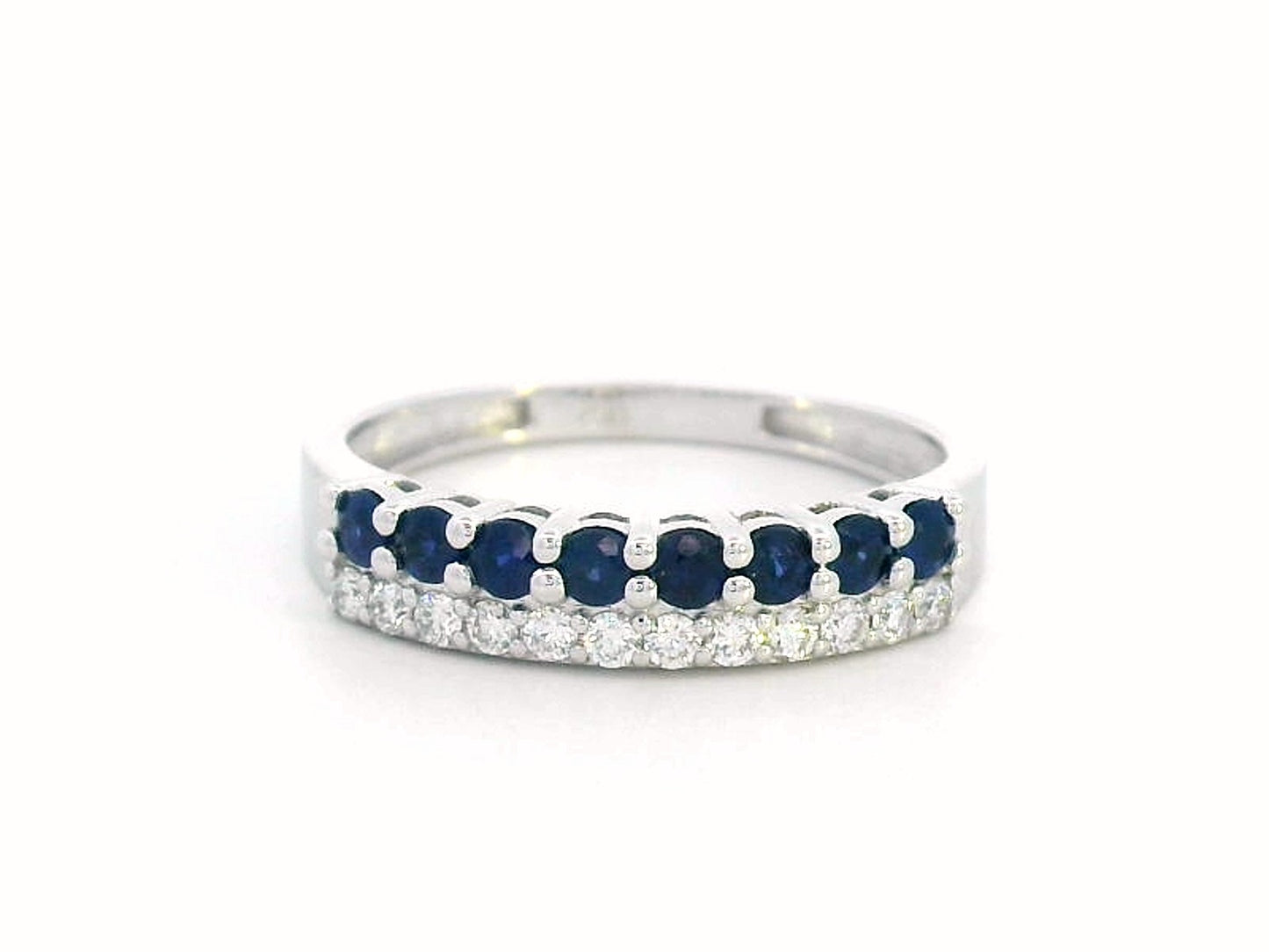 Elegant 18K gold sapphire and diamond ring featuring 0.54 carats of deep blue sapphires and 0.19 carats of brilliant diamonds. A timeless stacking band for weddings, anniversaries, and daily elegance.