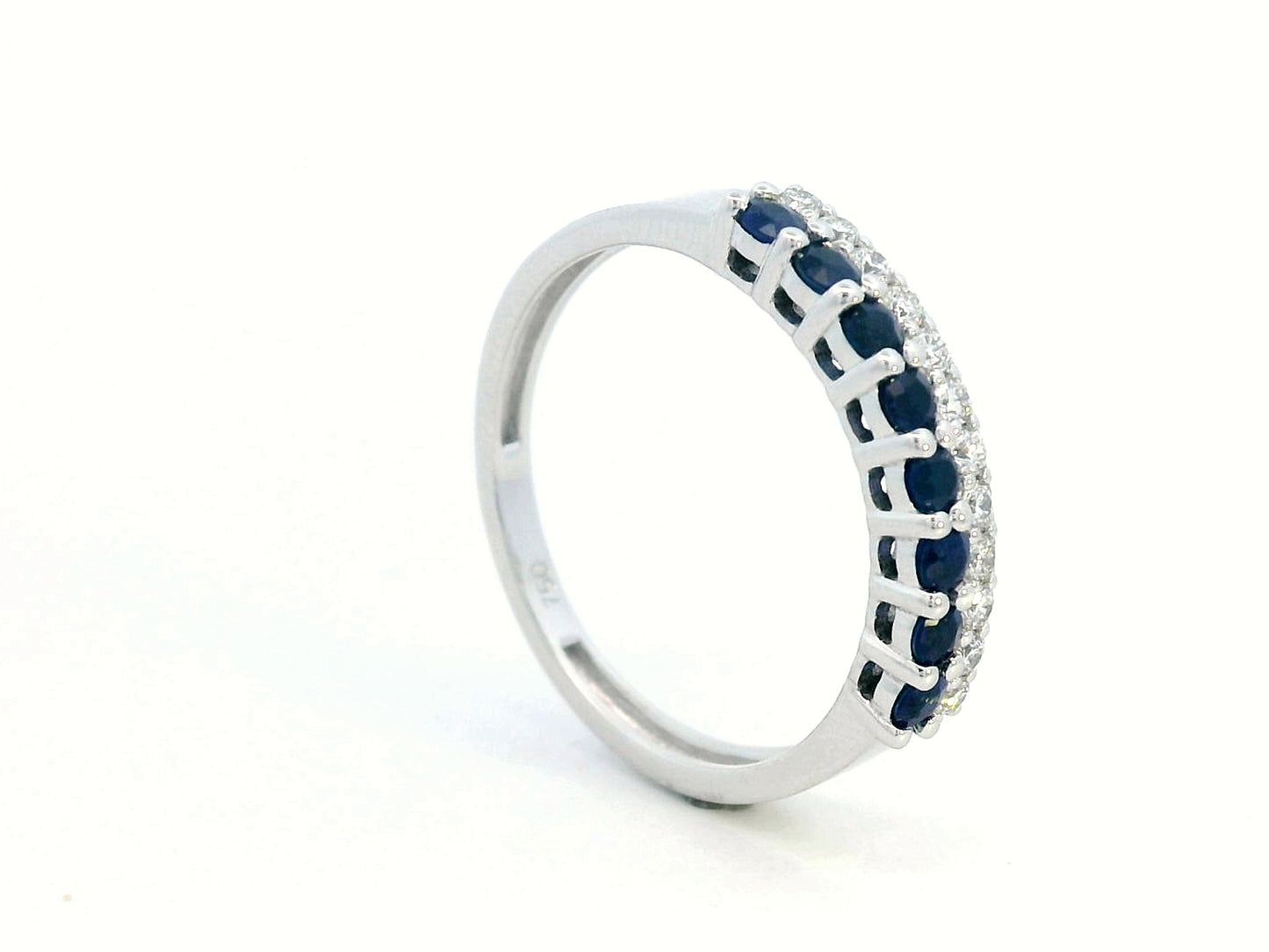 Elegant 18K gold sapphire and diamond ring featuring 0.54 carats of deep blue sapphires and 0.19 carats of brilliant diamonds. A timeless stacking band for weddings, anniversaries, and daily elegance.
