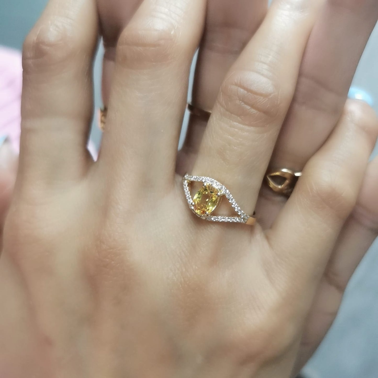 Elegant 18K gold yellow sapphire and diamond ring featuring a 1.05-carat yellow sapphire and 0.22 carats of brilliant diamonds in an open-frame design