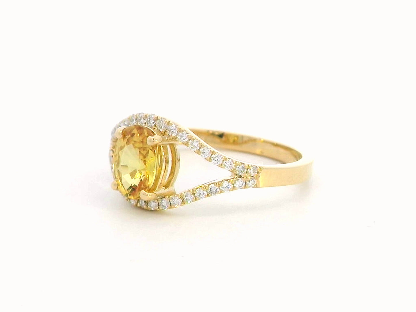 Elegant 18K gold yellow sapphire and diamond ring featuring a 1.05-carat yellow sapphire and 0.22 carats of brilliant diamonds in an open-frame design