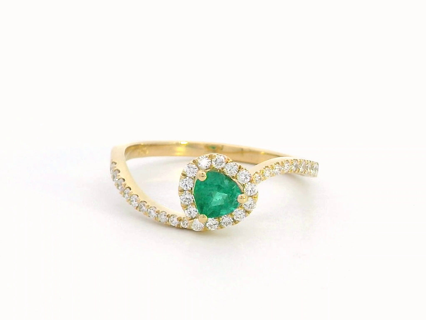 Heart-cut emerald ring with a diamond halo in 18K gold, featuring a bypass design for a timeless and elegant look.