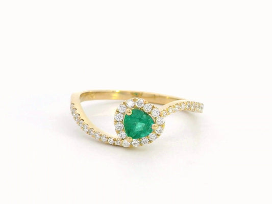 Heart-cut emerald ring with a diamond halo in 18K gold, featuring a bypass design for a timeless and elegant look.