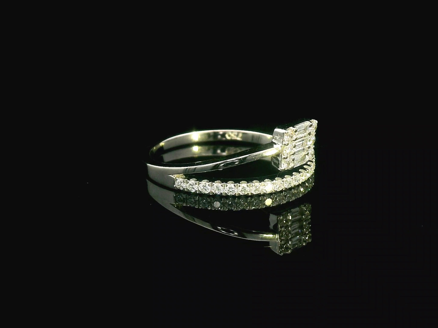 18K gold ring with round and baguette diamonds, showcasing a modern asymmetrical split-band design.