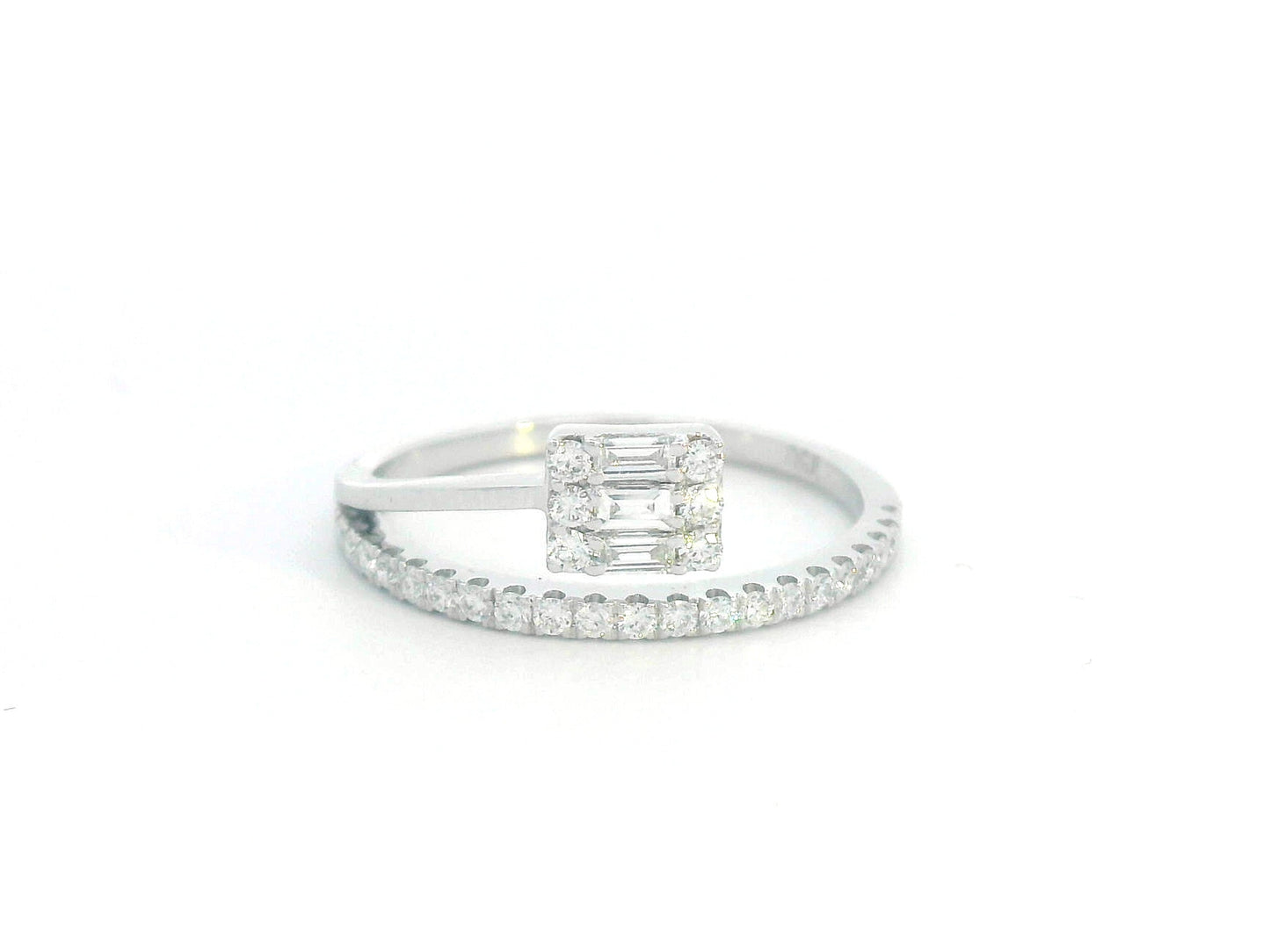 18K gold ring with round and baguette diamonds, showcasing a modern asymmetrical split-band design.