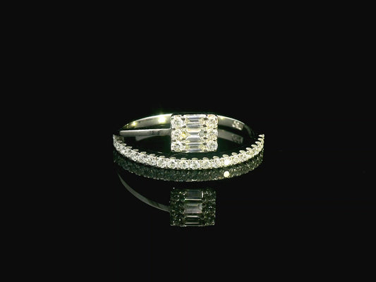 18K gold ring with round and baguette diamonds, showcasing a modern asymmetrical split-band design.