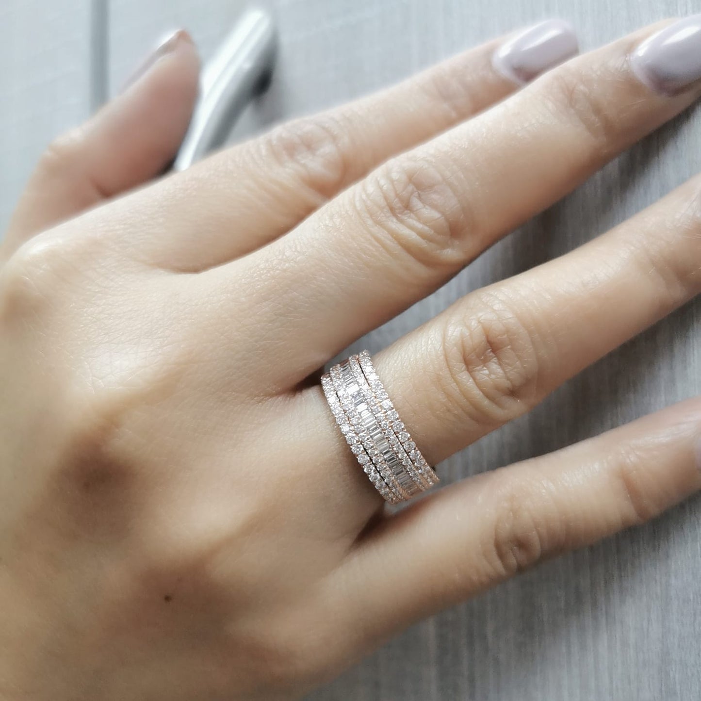 18K rose gold multi-row diamond band with round and baguette diamonds.