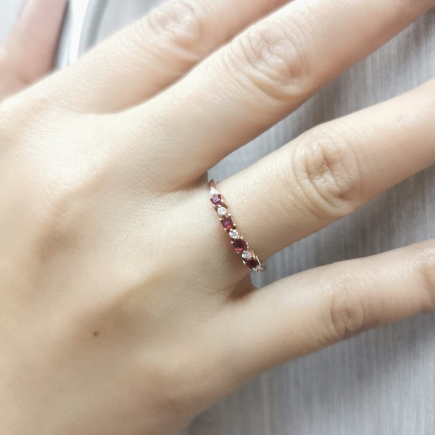 18K rose gold ring with alternating square-cut rubies and diamonds – Perfect for stacking or as a birthstone ring.