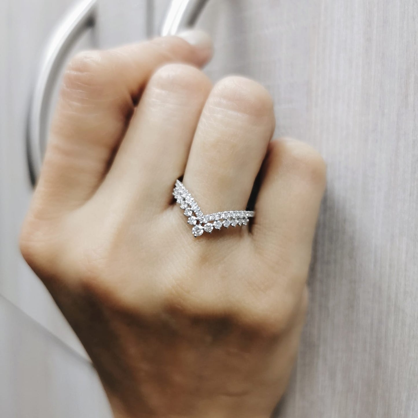 18K gold V-shape diamond ring with 0.47 carat round diamonds in a chevron silhouette