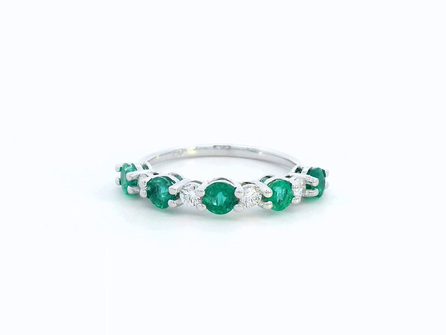 Elegant 18K white gold band with alternating round emeralds and diamonds – 0.94ct emeralds and 0.25ct diamonds.