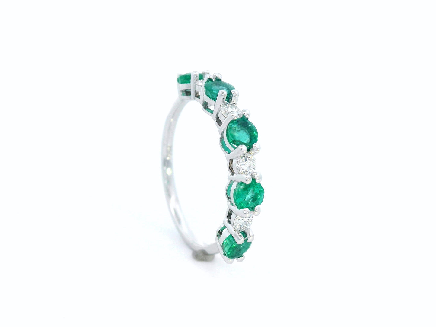 Elegant 18K white gold band with alternating round emeralds and diamonds – 0.94ct emeralds and 0.25ct diamonds.