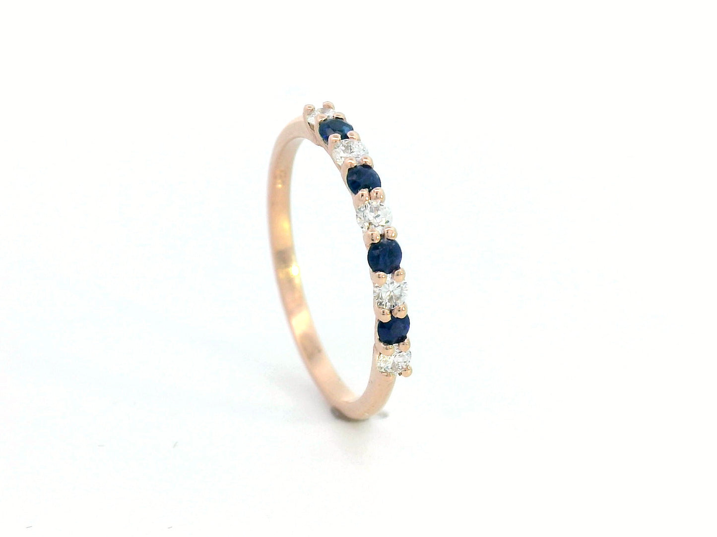 18K rose gold half eternity ring with alternating blue sapphires and diamonds