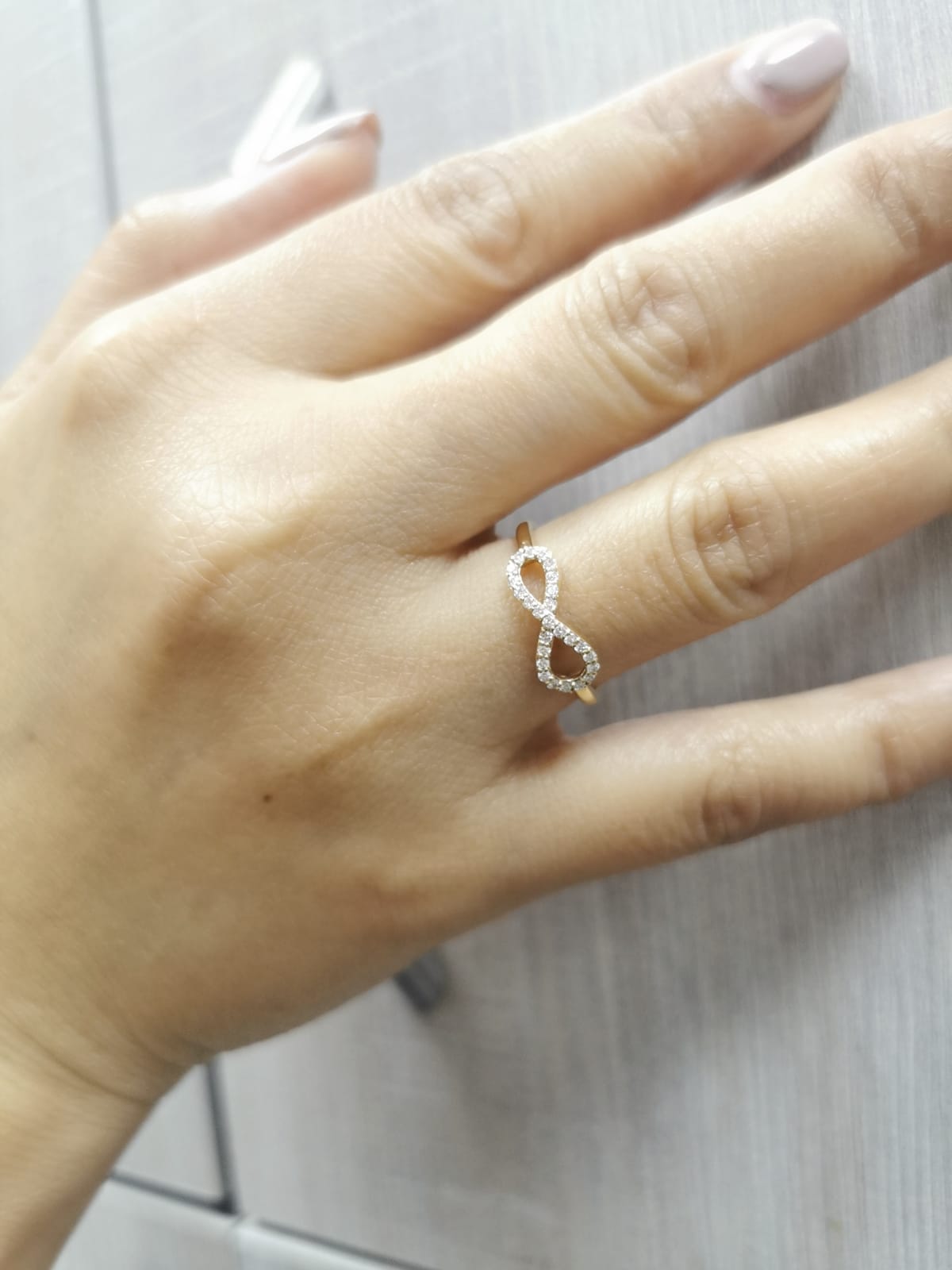 18K gold infinity ring with diamonds, symbolizing love, friendship & eternity.