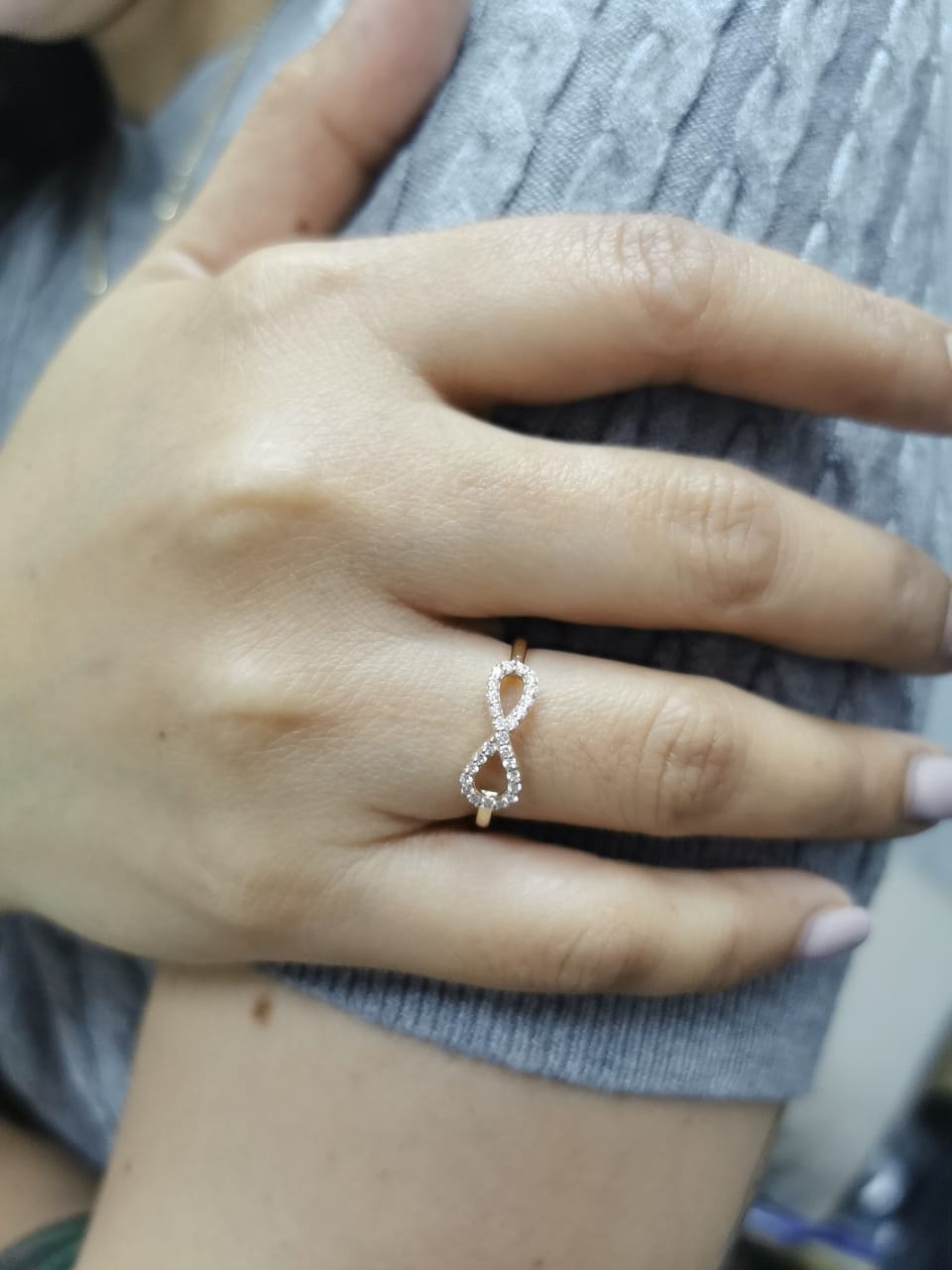 18K gold infinity ring with diamonds, symbolizing love, friendship & eternity.