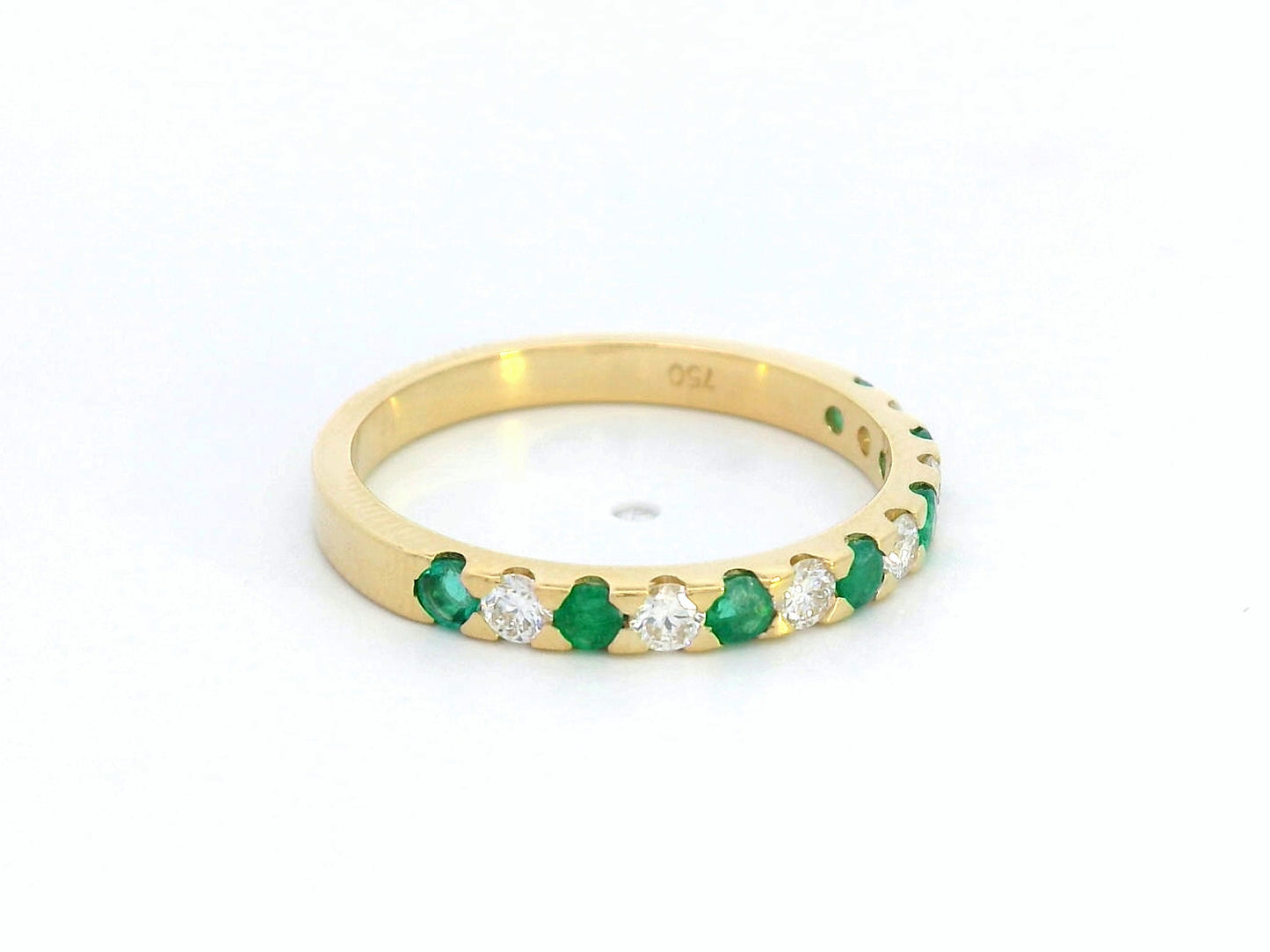 18K yellow gold eternity band with alternating emerald and diamond stones, elegant stacking ring