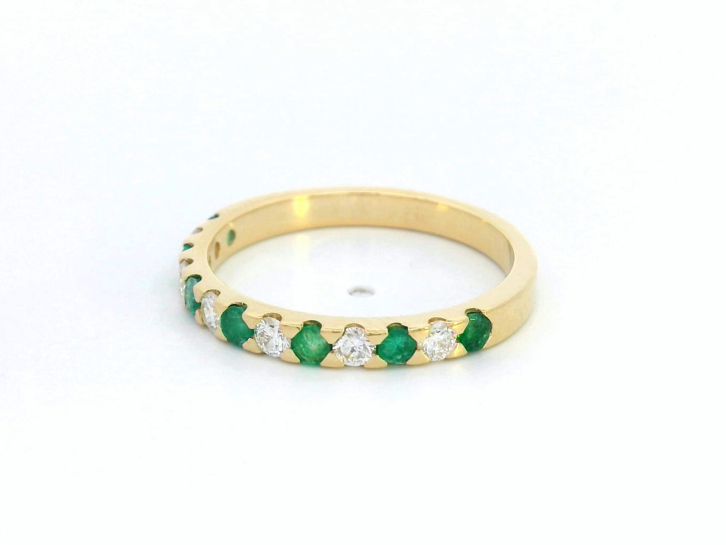 18K yellow gold eternity band with alternating emerald and diamond stones, elegant stacking ring