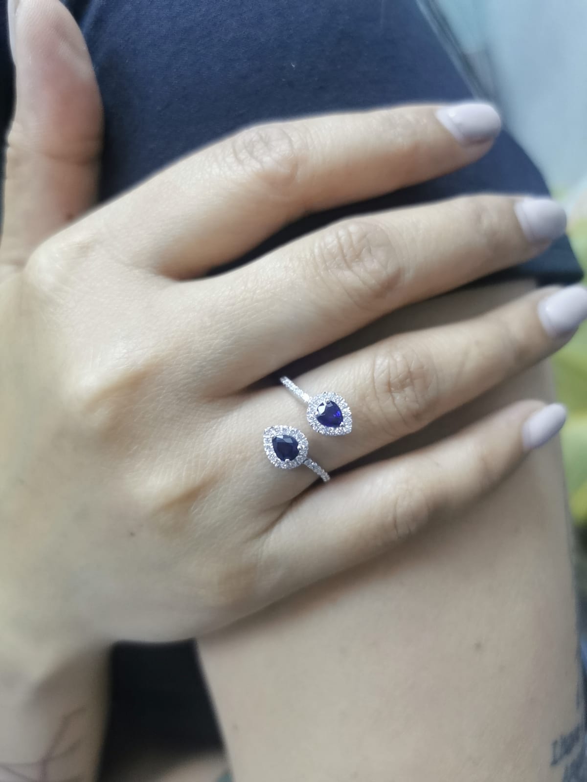 Pear-shaped sapphire and diamond bypass ring in 18K white gold with double halo design