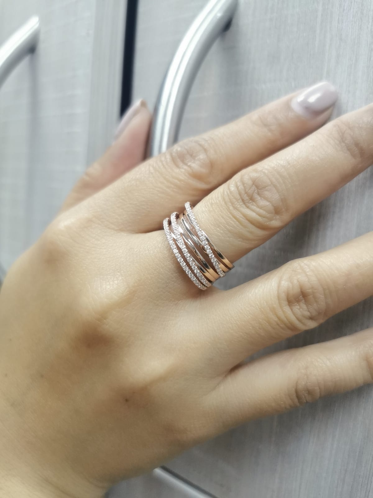 18K rose gold crossover ring with 0.46 carat round pavé diamonds, layered multi-band statement design.