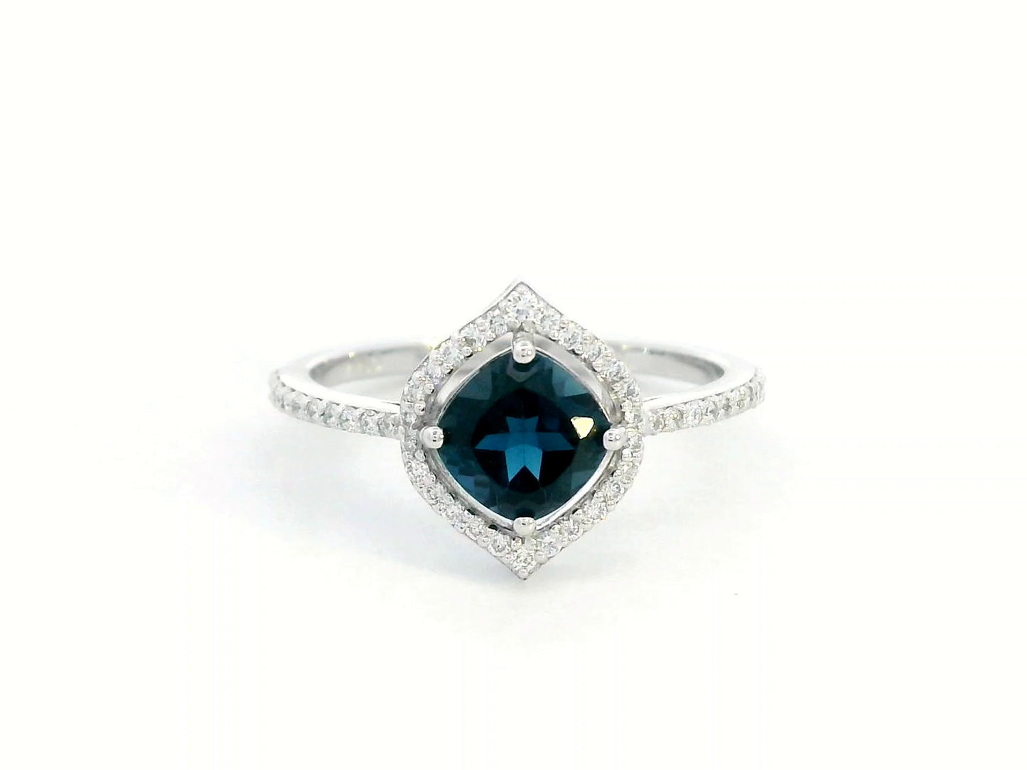 Cushion-cut London Blue Topaz ring with diamond halo and pavé diamond band in 18K gold