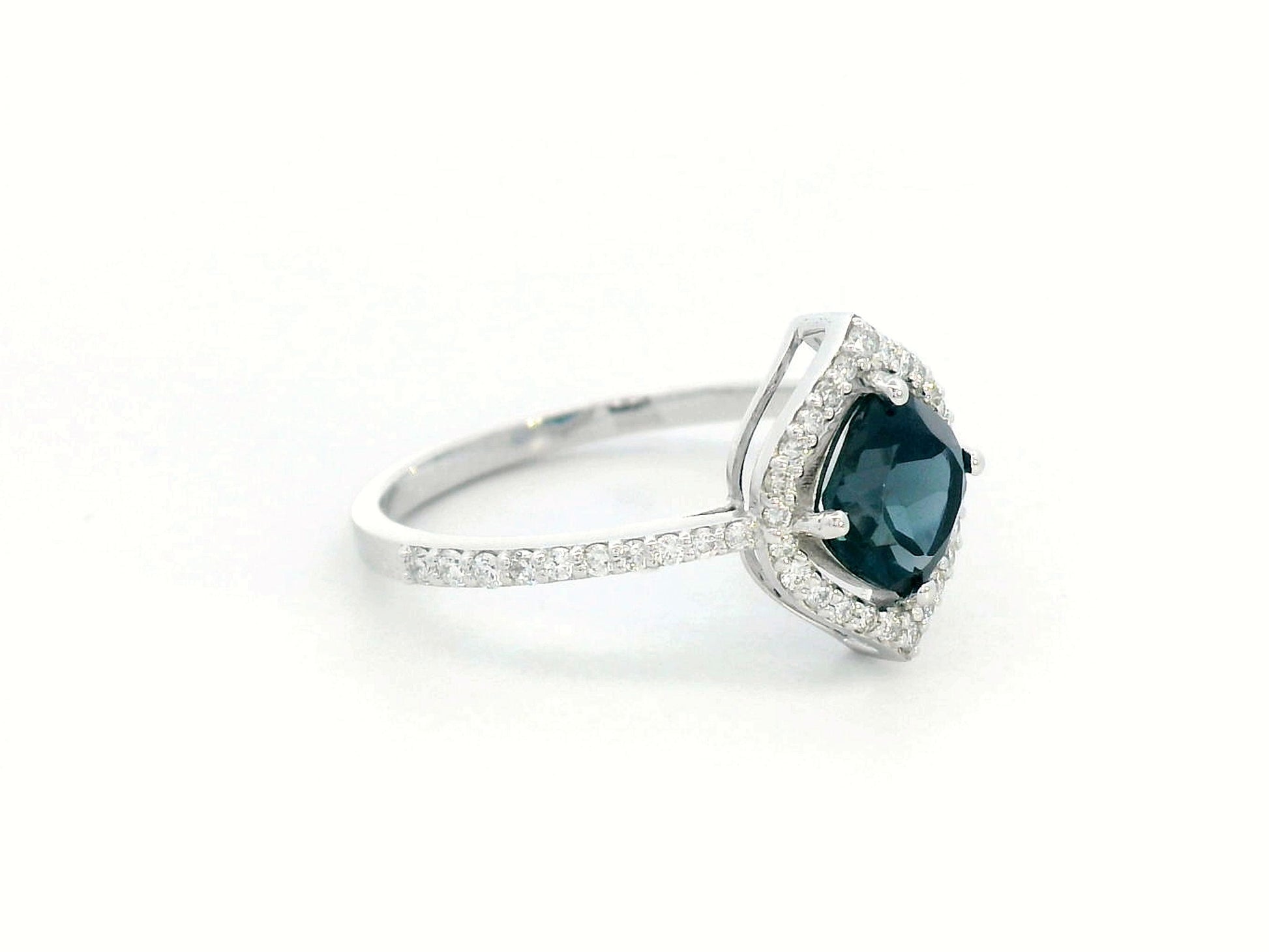 Cushion-cut London Blue Topaz ring with diamond halo and pavé diamond band in 18K gold
