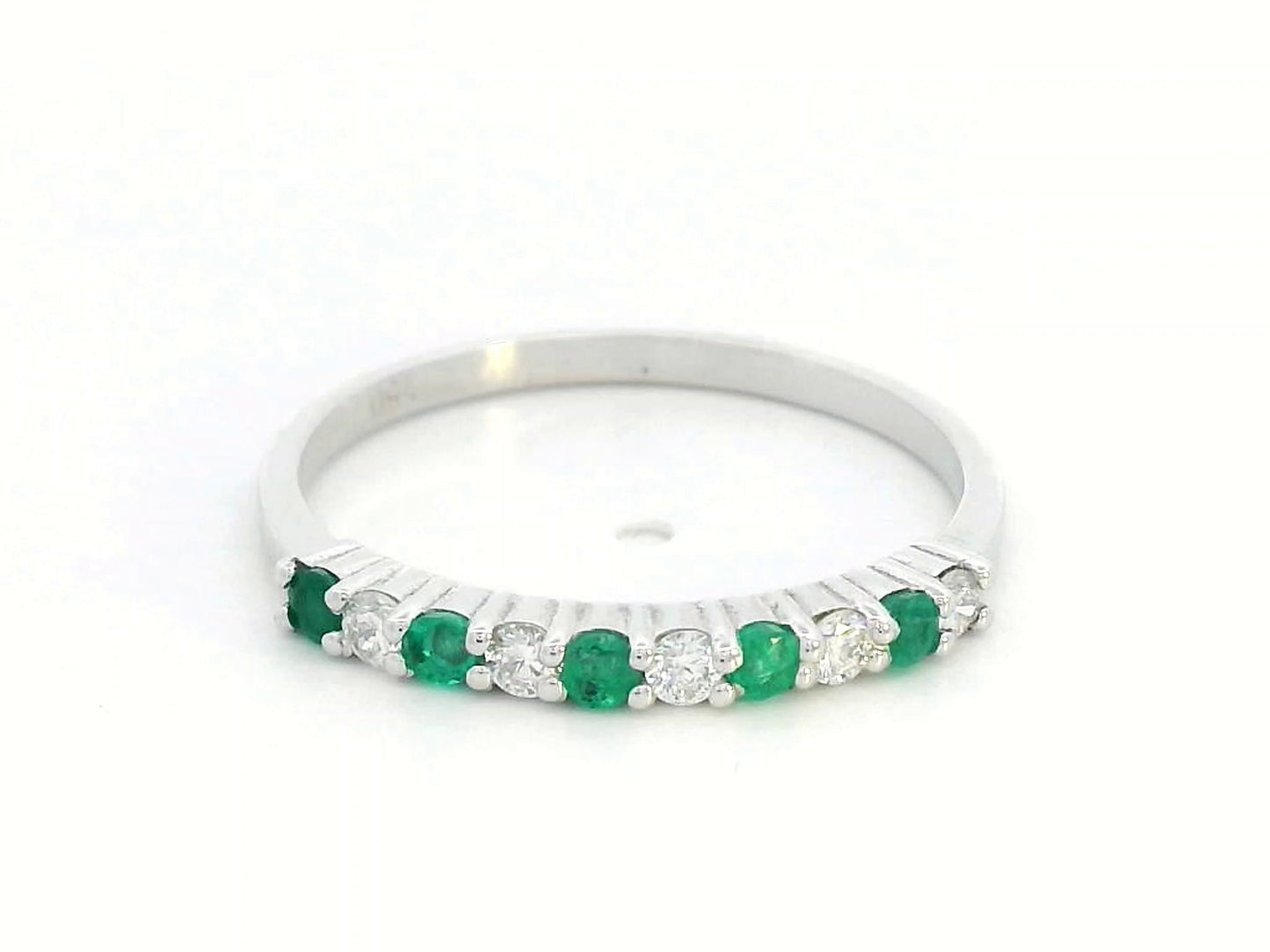 18K white gold half-eternity ring with alternating emeralds and diamonds, stackable wedding band design.