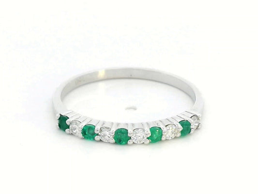 18K white gold half-eternity ring with alternating emeralds and diamonds, stackable wedding band design.